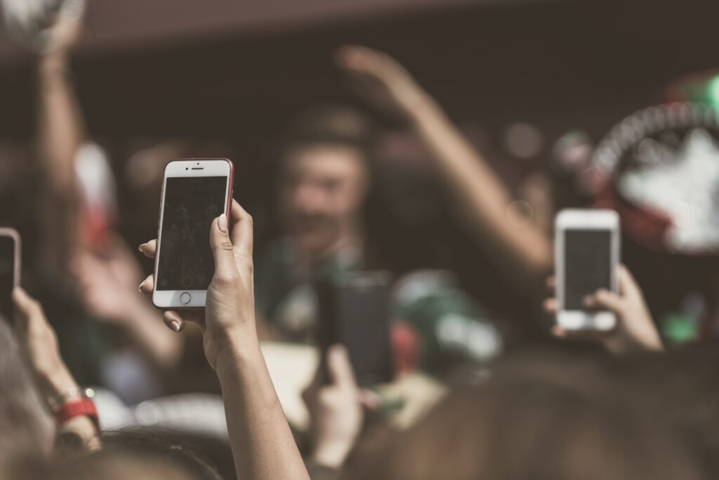 Phones in a crowd of people